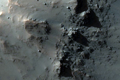 Clay and Pyroxene-Rich Materials Exposed by Crater in East Thaumasia Planum