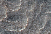 Crater with Dark Ellipsoid Ejecta Blanket