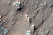 Bright Blocks in Eroded Materials near Thaumasia Planum