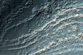 Exposed Layers of Bright Bedrock near Voeykov Crater