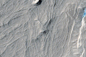 Layers and Ridges in Degraded Crater West of Lucus Planum