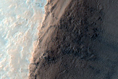 Crater and Possible Olivine-Rich Terrain on Plains Southwest of Toro Crater