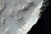 Possible Hydrated Materials on Rim of Crater in Thaumasia Planum