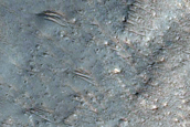 Possible Impact Melt Breccias within Saheki Ejecta Blanket