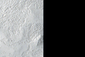 Fresh Crater Surrounded by Amazonis Planitia Lava Plains with Asymmetry