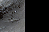 Exposed Bedrock with Steep Slopes near 28-Meter Diameter Fresh Crater