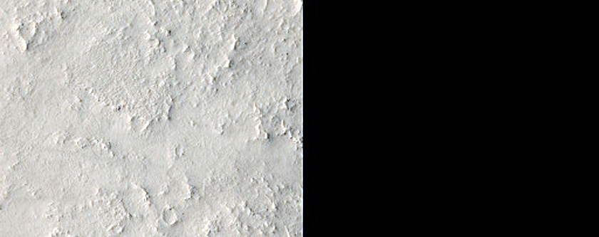 Small Crater and Exposed Bedrock in Arabia Terra