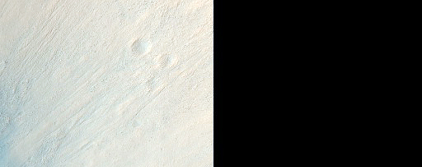 Layered Material in Idaeus Fossae Crater Wall