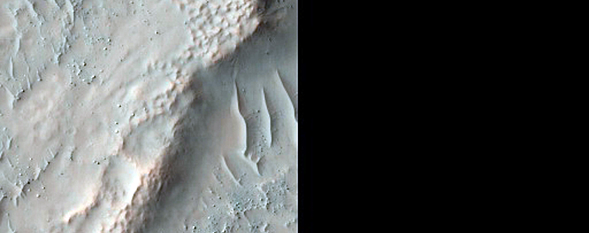 Bedrock Exposures in Crater in Aonia Terra