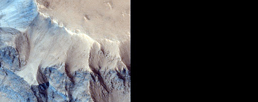 Dark Material Eroding from Crater Rim