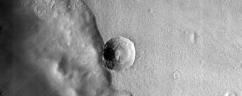 Sub-Kilometer Well-Preserved Impact Crater with Extensive Secondaries