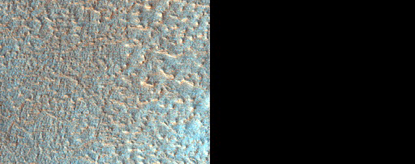 Ejecta Blanket of Heavily Modified Crater in Terrain with Diverse Textures