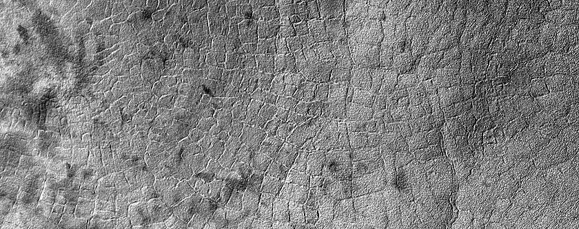 Crater in Aonia Terra