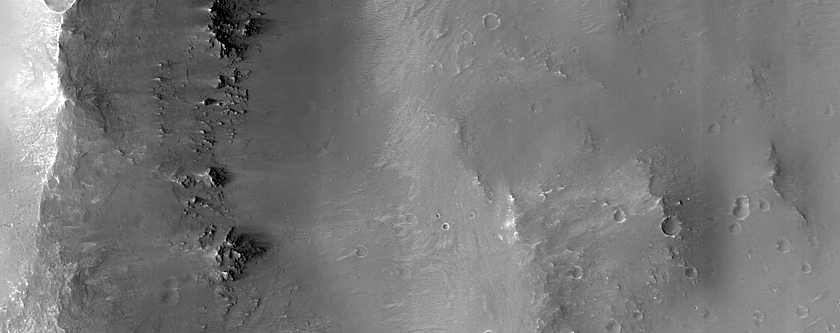 Diverse Materials in Degraded Crater Rim near Her Desher Vallis 
