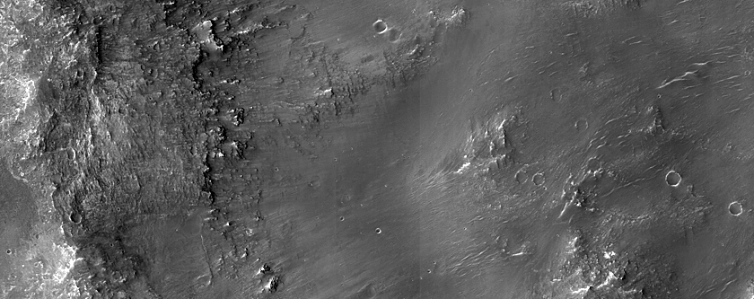 Diverse Materials in Degraded Crater Rim near Her Desher Vallis 