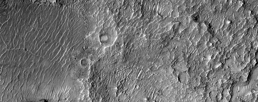 Layered Materials at Deepest Point of Crater Fed by Channels