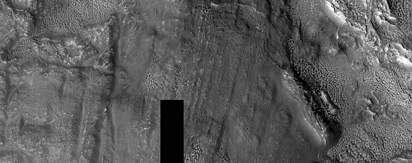 Interaction of Ejecta with Ridge and Trough Terrain in Deuteronilus Mensae