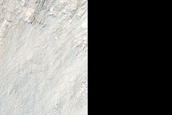 Layered Material in Idaeus Fossae Crater Wall