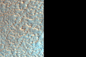 Ejecta Blanket of Heavily Modified Crater in Terrain with Diverse Textures