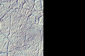 Icy Terrain with Polygonal Fractures in and around Craters