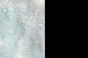 Linear Feature Exposure of Infrared-Bright Material in Louros Valles
