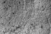 Crater in Aonia Terra