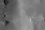 Diverse Materials in Degraded Crater Rim near Her Desher Vallis 