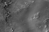 Diverse Materials in Degraded Crater Rim near Her Desher Vallis 