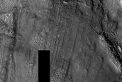 Interaction of Ejecta with Ridge and Trough Terrain in Deuteronilus Mensae