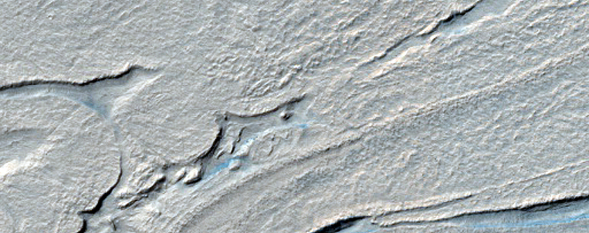 Twisted Surface Features in Hellas Planitia