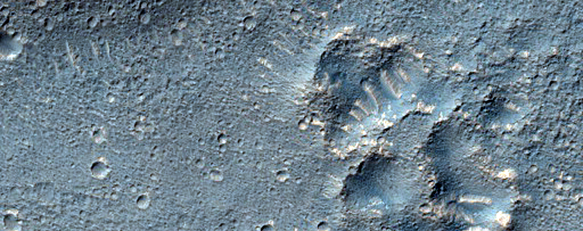 Layered Feature in Crater in Promethei Terra