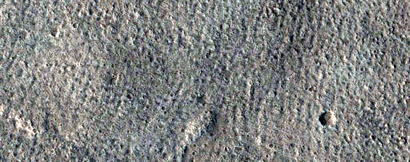 North-Pole-Facing Deposit in Crater Associated with Headwall Erosion