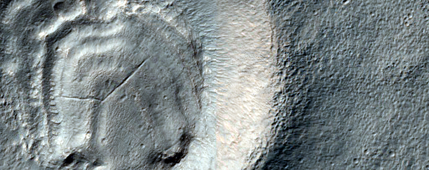 Layered Feature in Crater in Promethei Terra