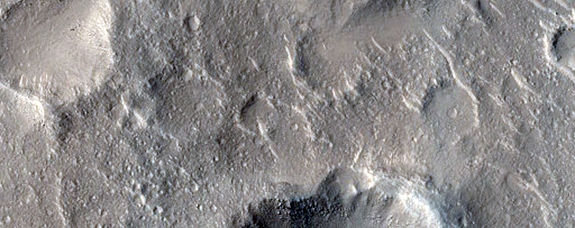 Small Mesas and Crater Clusters in Isidis Planitia