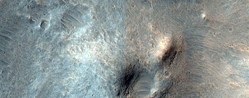 Crater with Fractured Floor North of Ganges Chasma