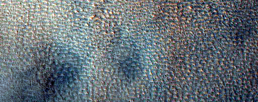 Possible Gully-Associated Light-Toned Materials in Scarp in Acidalia Colles