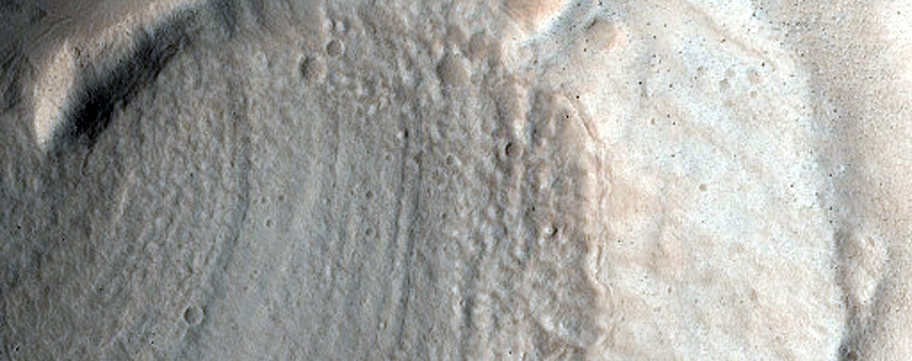North-Pole-Facing Deposit in Crater Associated with Headwall Erosion