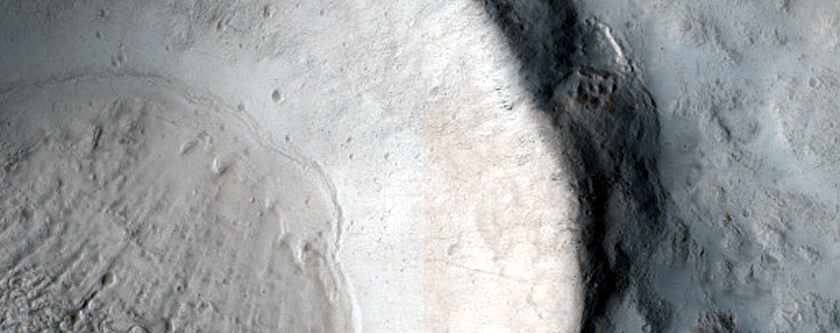 North-Pole-Facing Deposit in Kilometer-Sized Crater