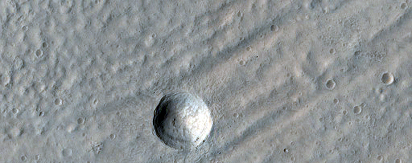 Crater Exposing Structure of Glacial Fill inside Baphyras Catena