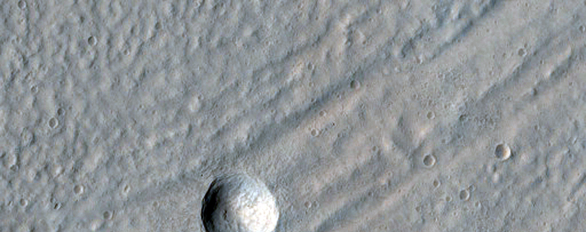 Crater Exposing Structure of Glacial Fill inside Baphyras Catena