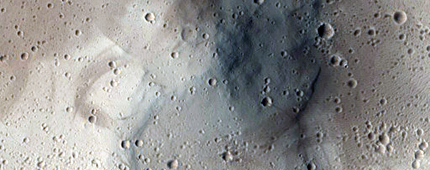 Deflated-Looking Pole-Facing Deposit in Crater in Tharsis Region