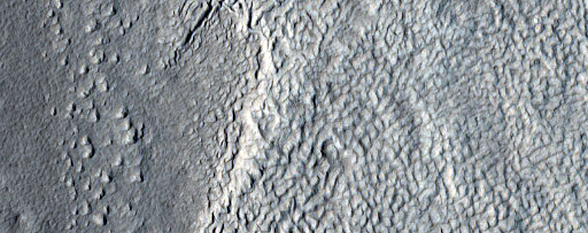 Crater Exposing Layers in Icy Deposits