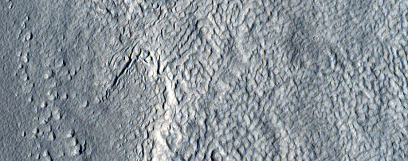 Crater Exposing Layers in Icy Deposits