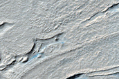 Twisted Surface Features in Hellas Planitia