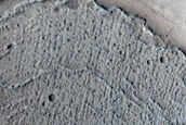 North-Pole-Facing Deposit in Crater Associated with Headwall Erosion