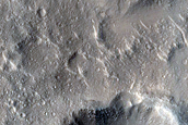 Small Mesas and Crater Clusters in Isidis Planitia