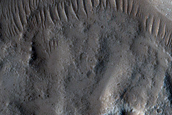 North-Pole-Facing Deposit in Crater Associated with Headwall Erosion