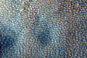 Possible Gully-Associated Light-Toned Materials in Scarp in Acidalia Colles