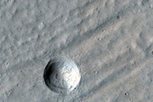 Crater Exposing Structure of Glacial Fill inside Baphyras Catena