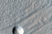 Crater Exposing Structure of Glacial Fill inside Baphyras Catena